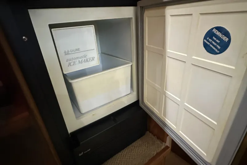 Slide: The Image of 1991 Carver 33 Aft Cabin ice maker with open door, showing interior compartment. - 35