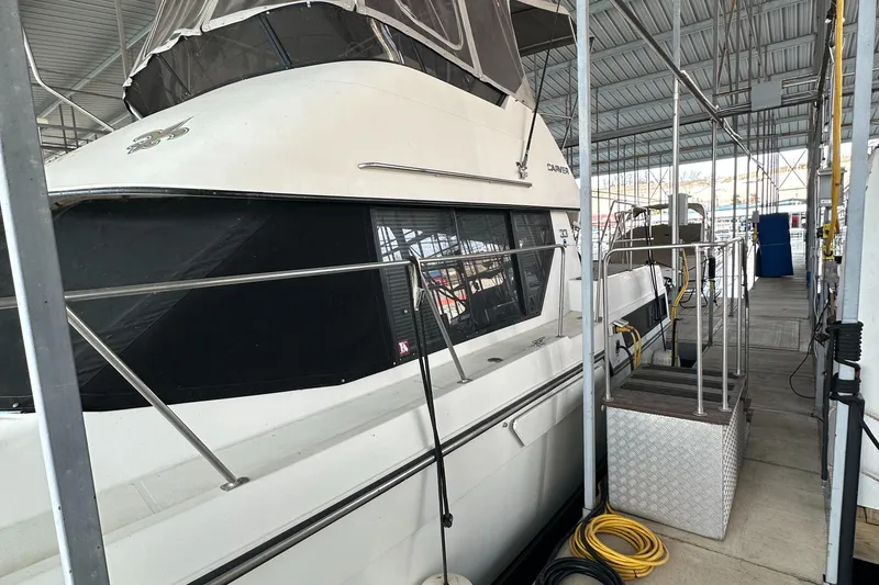 Slide: The Image of 1991 Carver 33 Aft Cabin yacht docked in a covered marina. - 4