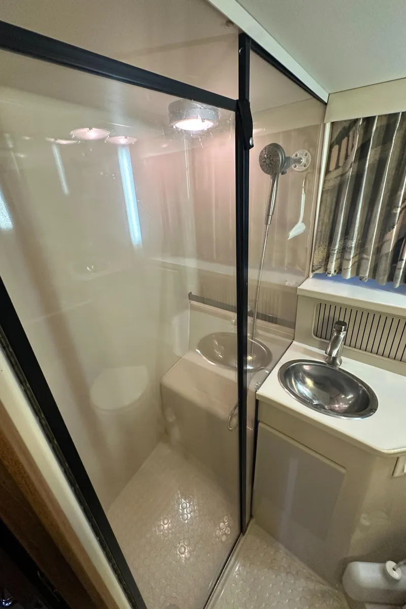 Slide: The Image of 1991 Carver 33 Aft Cabin bathroom with shower and sink. - 40