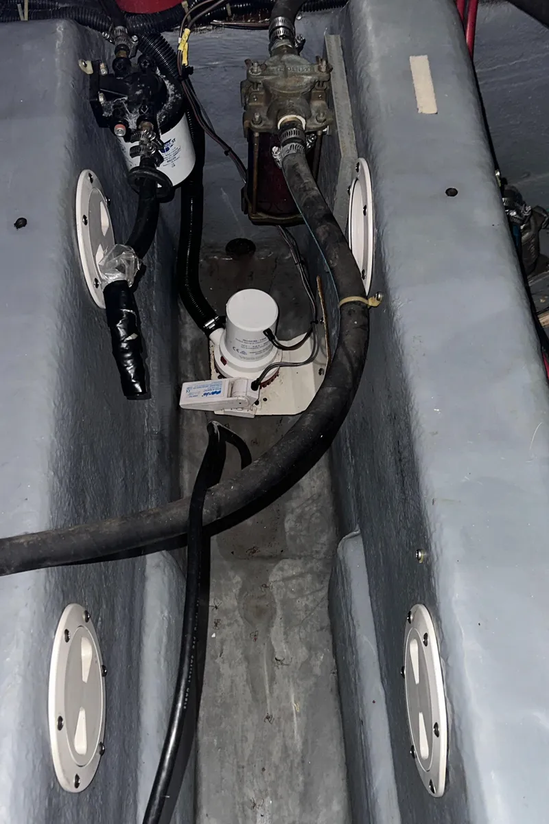 Slide: The Image of Engine compartment of 1991 Carver 33 Aft Cabin boat, showing mechanical components and hoses. - 43