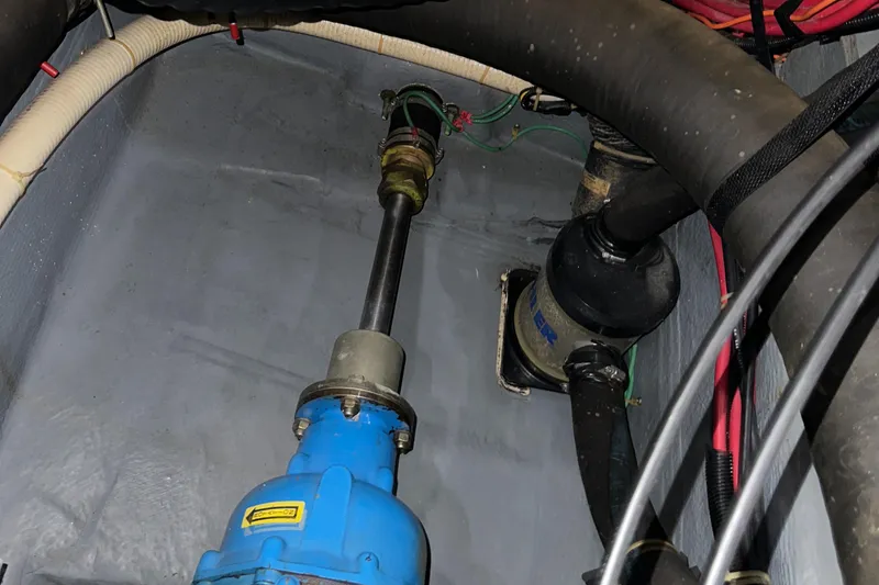 Slide: The Image of Engine compartment of 1991 Carver 33 Aft Cabin boat, showing mechanical components. - 46