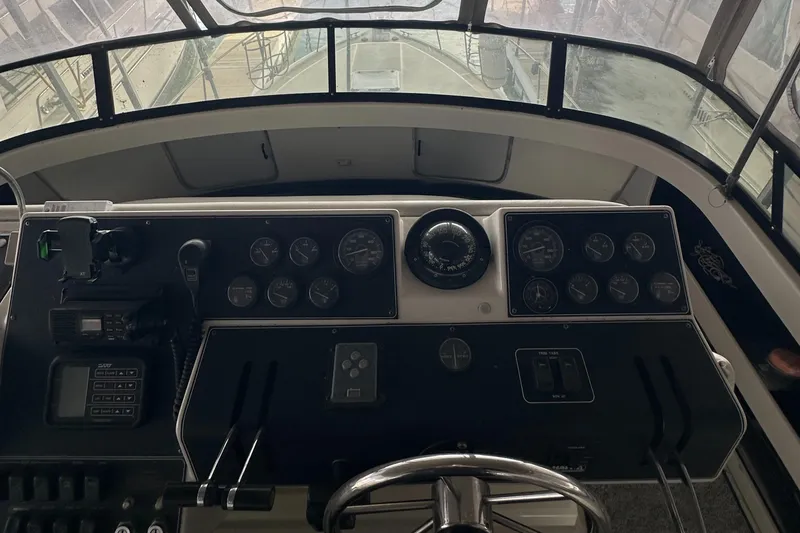 Slide: The Image of 1991 Carver 33 Aft Cabin helm with gauges and steering wheel. - 5