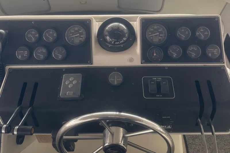 Slide: The Image of 1991 Carver 33 Aft Cabin dashboard with gauges and steering wheel. - 8