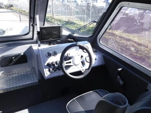 Slide: The Image of Interior of 2023 Duckworth Pacific Navigator 22' boat showing steering wheel and controls. - 10