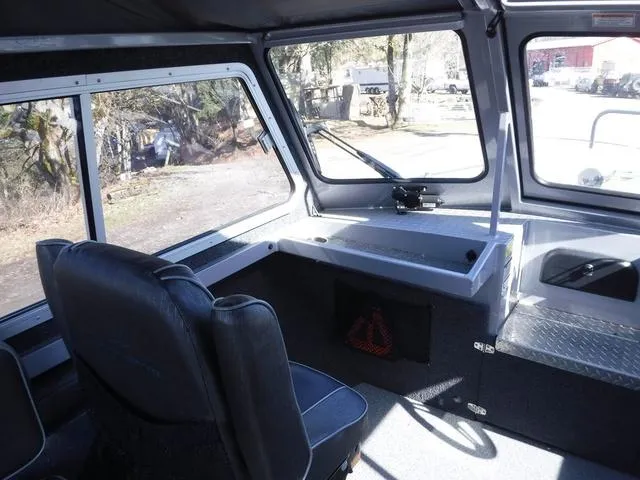 Slide: The Image of Interior of 2023 Duckworth Pacific Navigator 22' boat, featuring seating and helm area. - 11