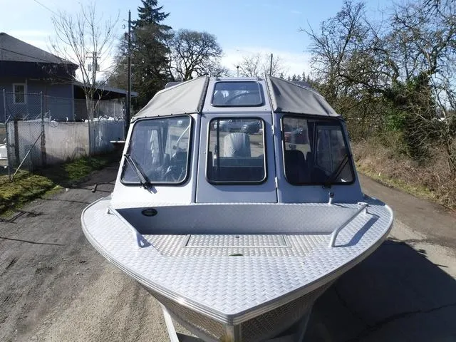 Slide: The Image of 2023 Duckworth Pacific Navigator 22' boat, front view, parked outdoors. - 6