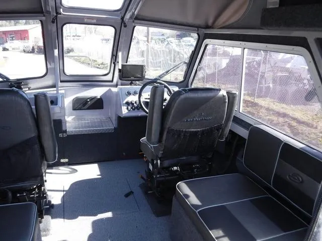 Slide: The Image of Interior of 2023 Duckworth Pacific Navigator 22' boat with seating and steering console. - 8
