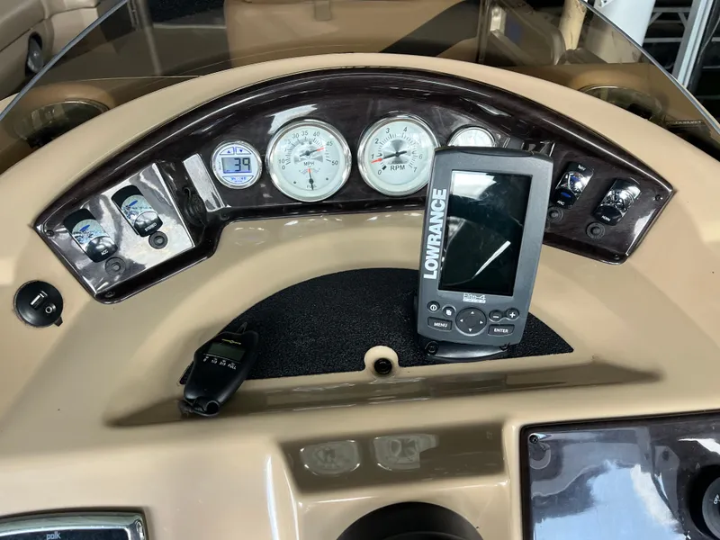 Slide: The Image of Dashboard of a 2014 Harris Cruiser 240 boat with Lowrance navigation system. - 11