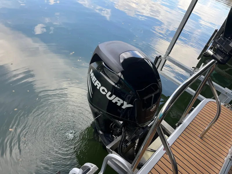 Slide: The Image of 2014 Harris Cruiser 240 with Mercury outboard motor on calm water. - 14