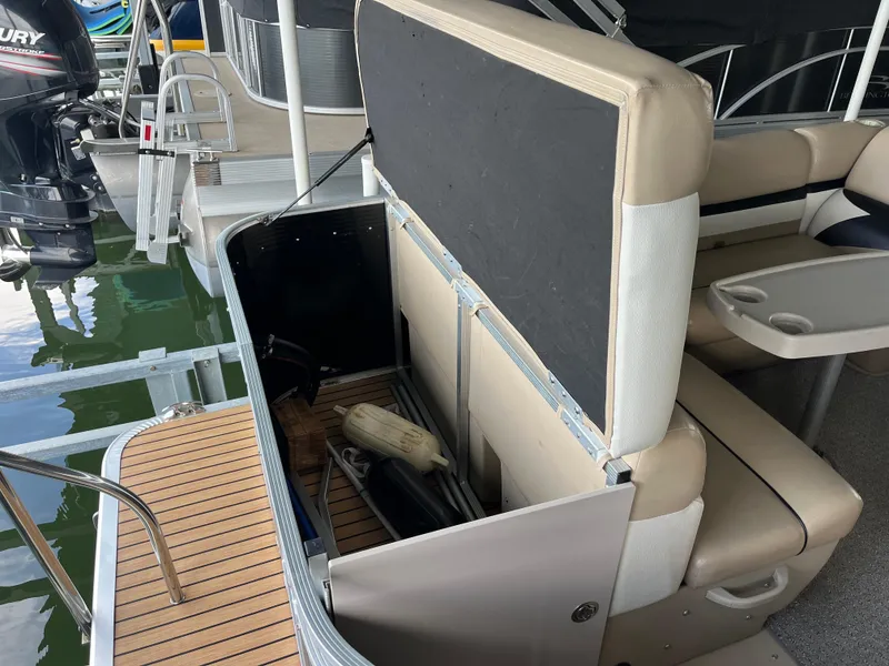 Slide: The Image of 2014 Harris Cruiser 240 boat with open storage compartment and seating area. - 15