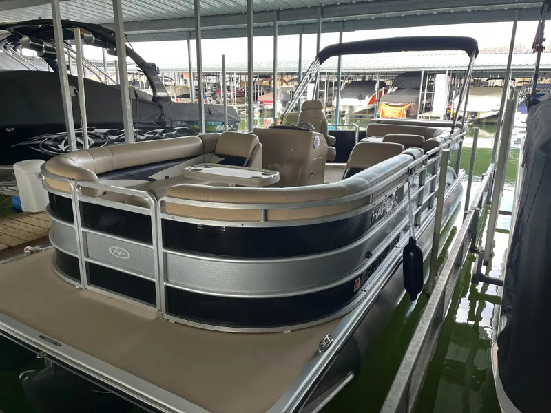 Slide: The Image of 2014 Harris Cruiser 240 pontoon boat docked in a marina. - 3