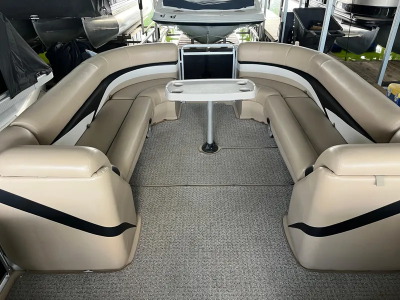 Slide: The Image of 2014 Harris Cruiser 240 pontoon boat interior with beige seating and central table. - 4