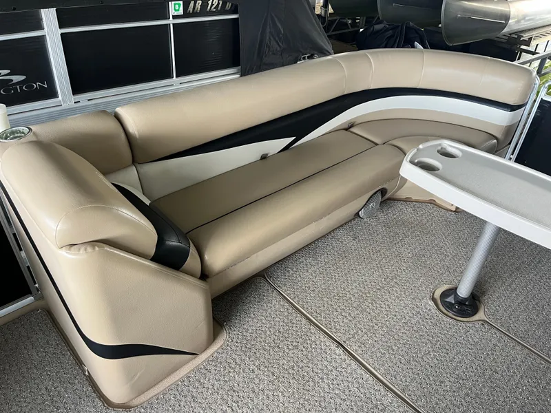 Slide: The Image of 2014 Harris Cruiser 240 boat interior with beige seating and a small table. - 5