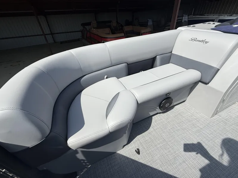 Slide: The Image of 2025 Bentley Pontoons Legacy Navigator 223 interior with luxurious gray seating. - 10