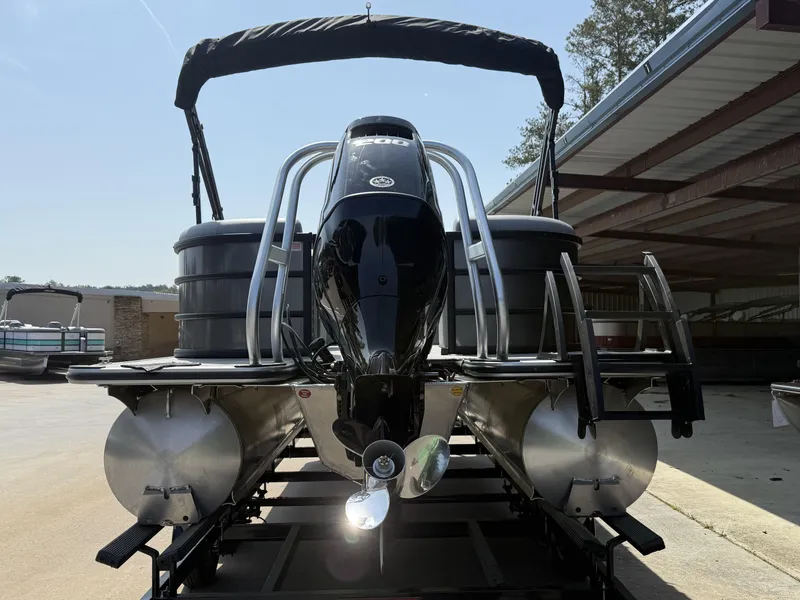 Slide: The Image of 2025 Bentley Pontoons Legacy Navigator 223, rear view, docked under a covered area. - 2