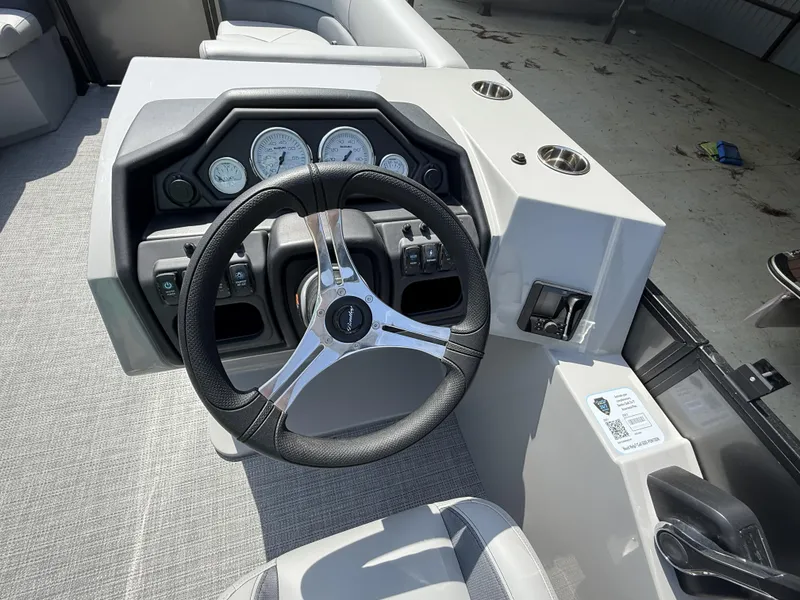 Slide: The Image of 2025 Bentley Pontoons Legacy Navigator 223 dashboard with steering wheel and gauges. - 6