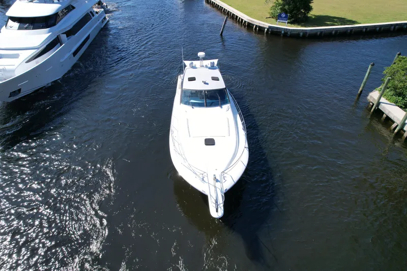 Slide: The Image of Aerial view of a 1999 Uniesse 57 Open yacht navigating a narrow waterway. - 12