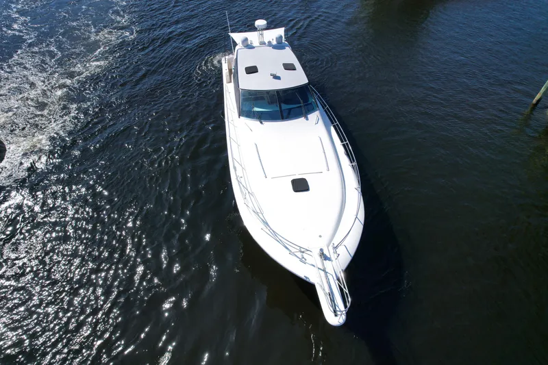 Slide: The Image of Aerial view of 1999 Uniesse 57 Open yacht cruising on water. - 13