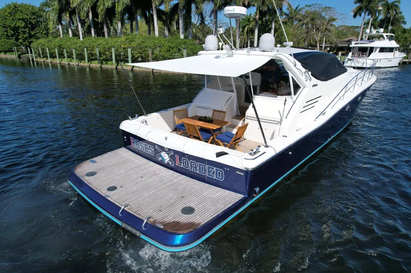 Slide: The Image of 1999 Uniesse 57 Open yacht cruising on a scenic waterway. - 16