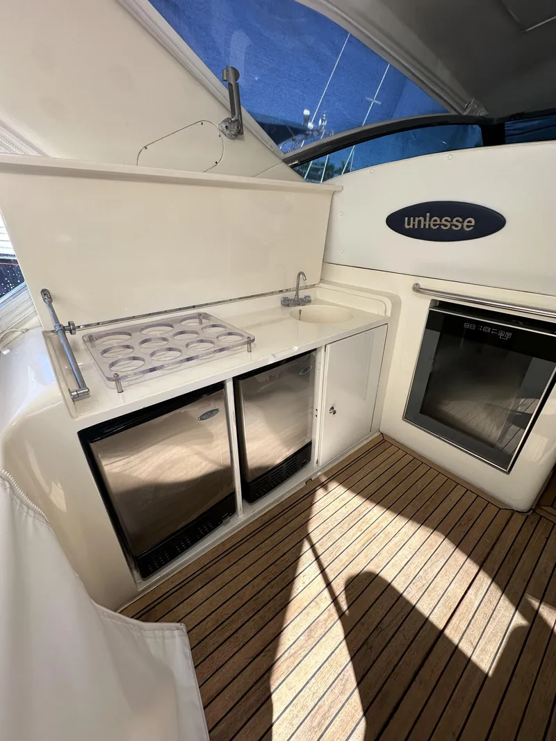 Slide: The Image of 1999 Uniesse 57 Open yacht interior with kitchenette and wooden flooring. - 20