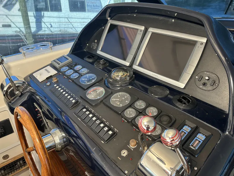 Slide: The Image of Control panel of a 1999 Uniesse 57 Open yacht with dual screens and gauges. - 31