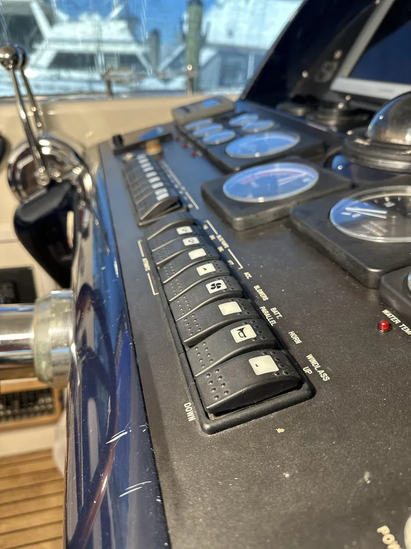 Slide: The Image of Control panel of a 1999 Uniesse 57 Open yacht, featuring switches and gauges. - 35