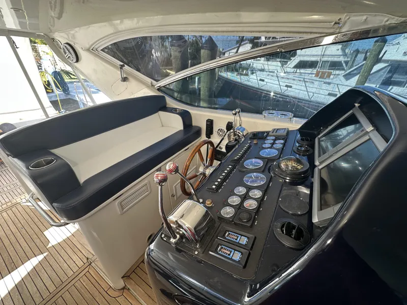Slide: The Image of 1999 Uniesse 57 Open yacht helm with navigation controls and seating. - 39