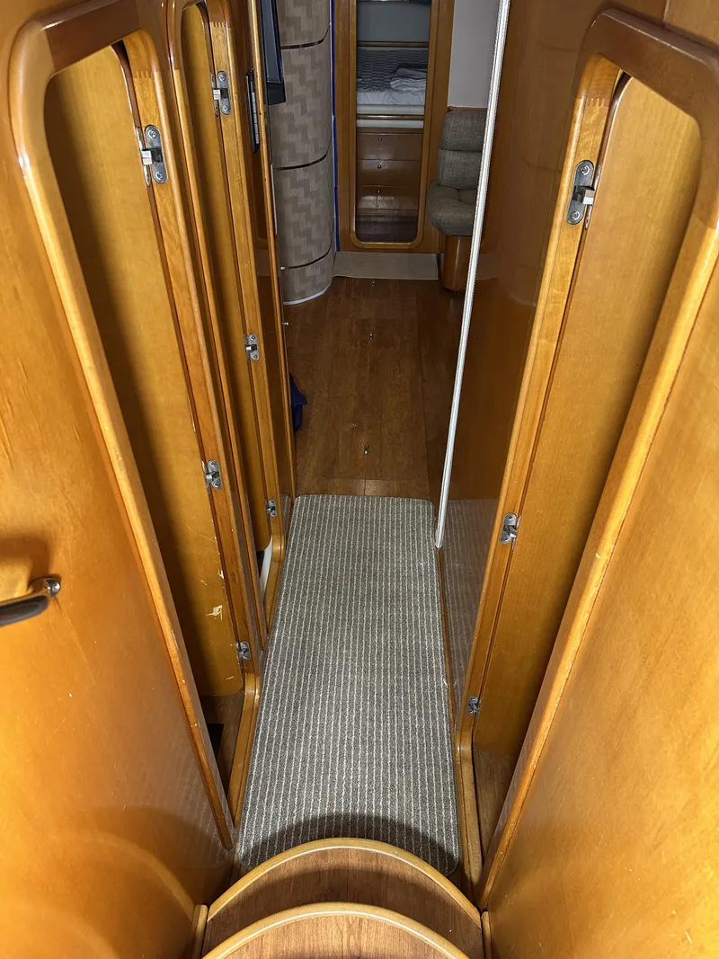 Slide: The Image of Interior hallway of 1999 Uniesse 57 Open yacht with wooden finishes. - 44