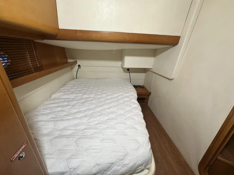 Slide: The Image of 1999 Uniesse 57 Open cabin with a cozy bed and wooden accents. - 47