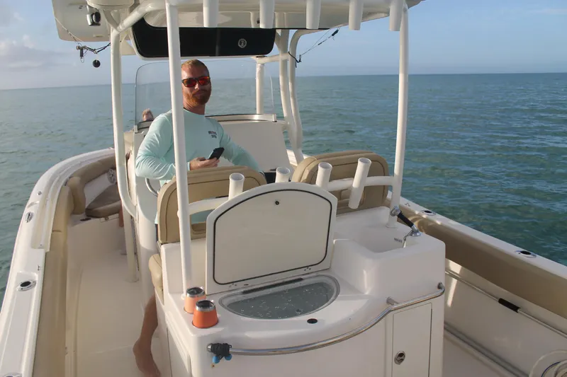 Slide: The Image of Man relaxing on a 2017 Key West Billistic 261 Center Console boat at sea. - 12