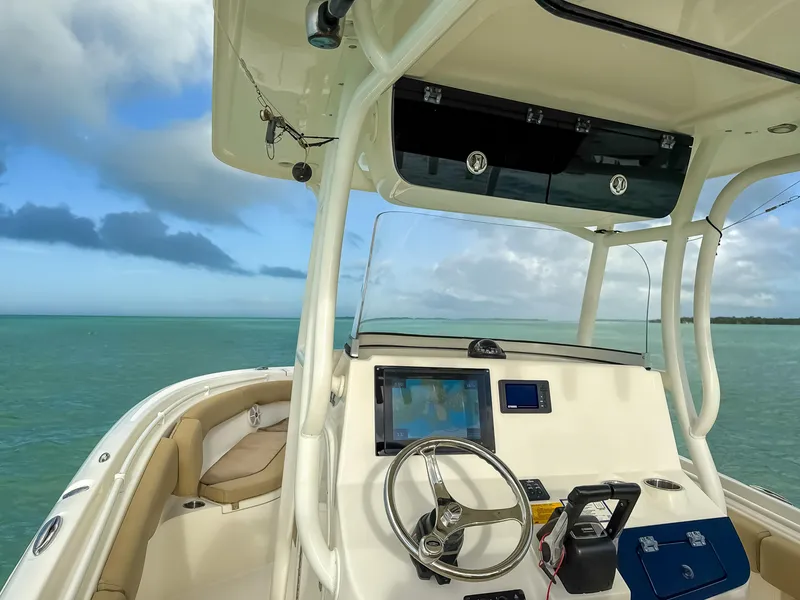 Slide: The Image of 2017 Key West Billistic 261 Center Console boat on open water, featuring modern helm controls. - 13
