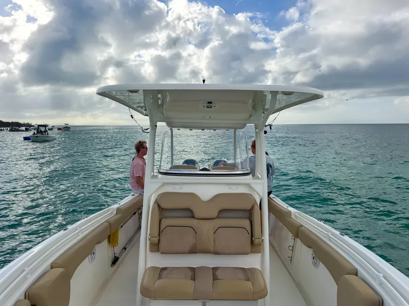 Slide: The Image of 2017 Key West Billistic 261 Center Console boat on open water under cloudy sky. - 16