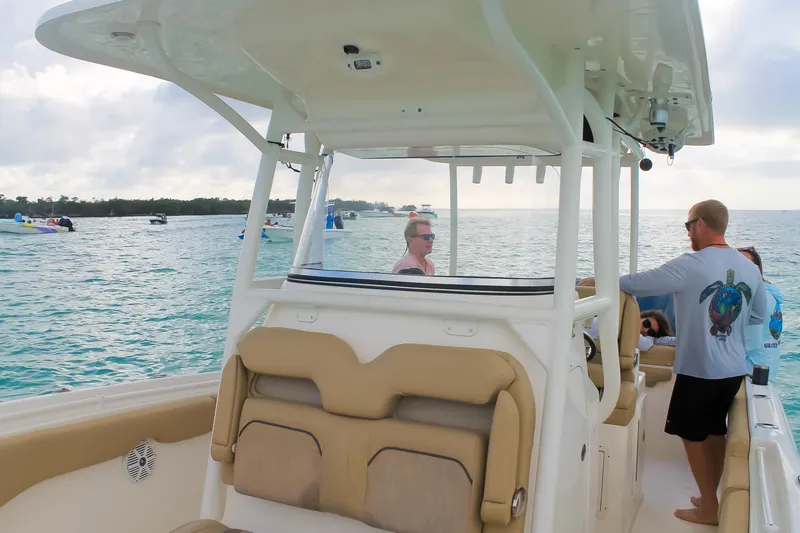 Slide: The Image of 2017 Key West Billistic 261 Center Console on calm waters, featuring passengers enjoying the ride. - 18
