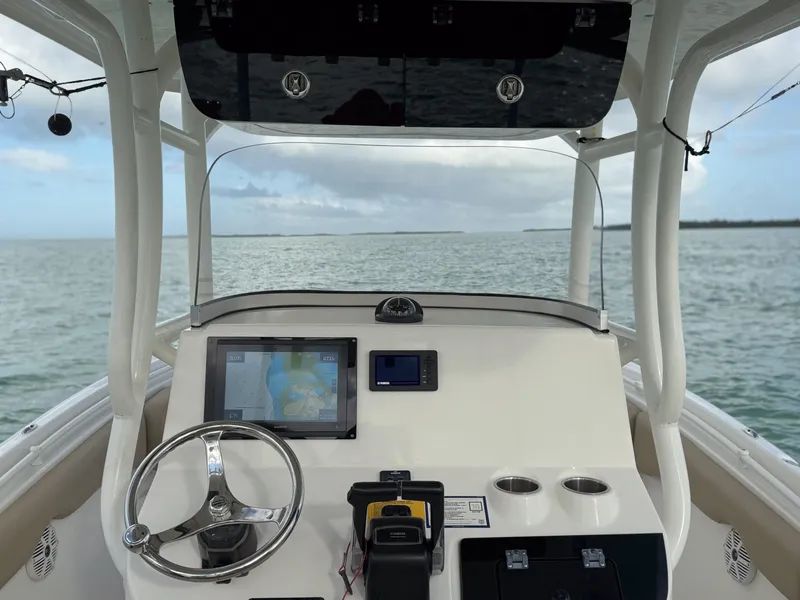 Slide: The Image of 2017 Key West Billistic 261 Center Console boat dashboard with ocean view. - 19
