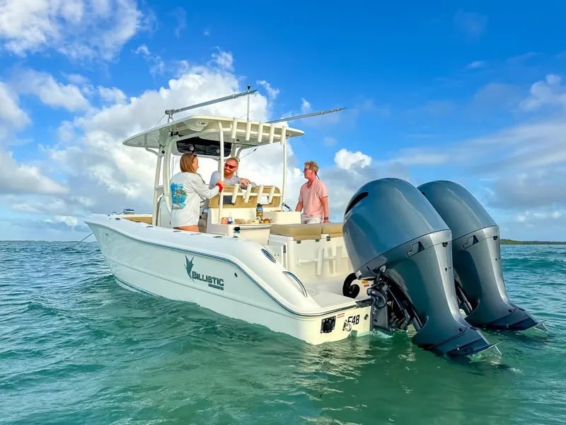 Slide: The Image of 2017 Key West Billistic 261 Center Console boat with people on board in open water. - 2