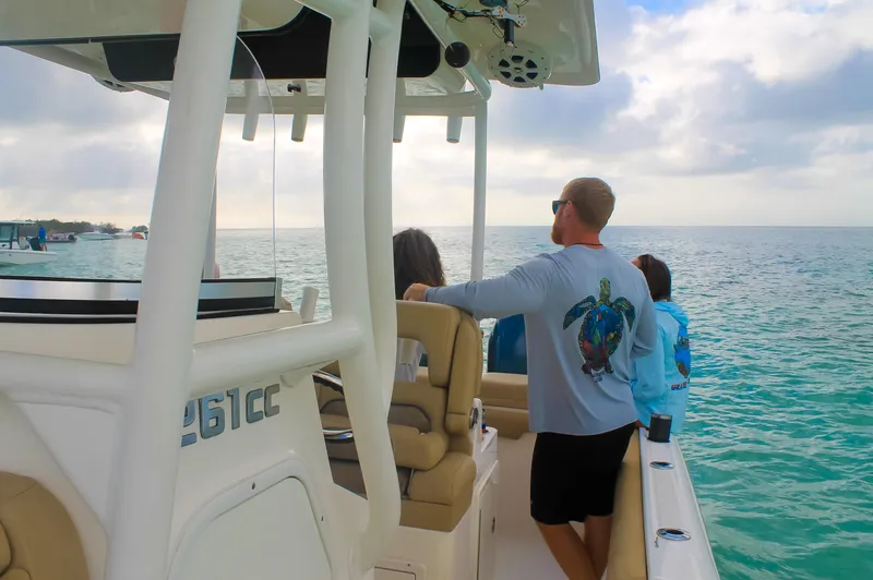 Slide: The Image of 2017 Key West Billistic 261 Center Console on calm ocean waters with passengers enjoying the view. - 22