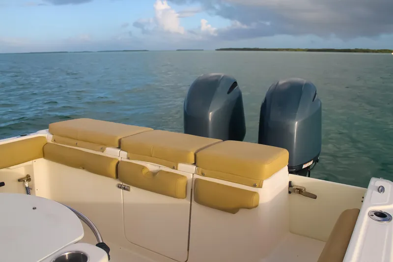 Slide: The Image of 2017 Key West Billistic 261 Center Console boat with dual engines on calm water. - 24