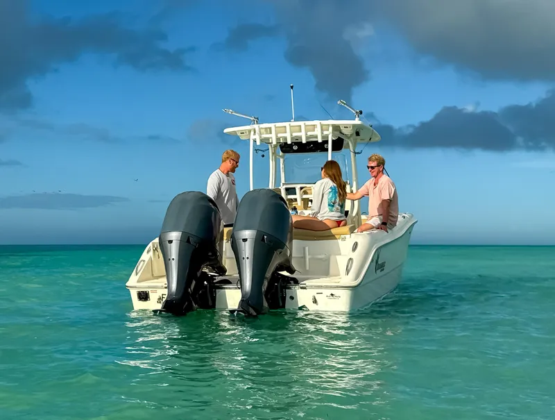 Slide: The Image of 2017 Key West Billistic 261 Center Console boat with three people on turquoise water. - 4