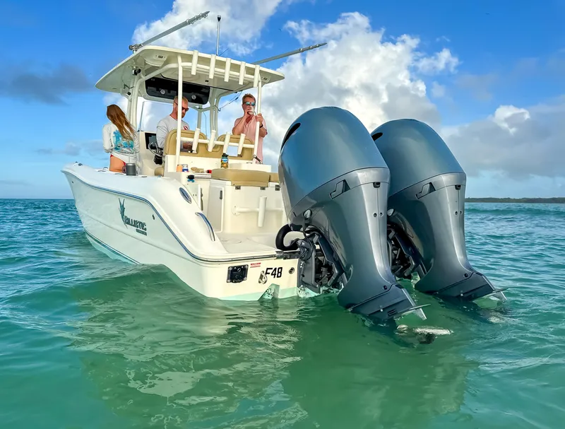 Slide: The Image of 2017 Key West Billistic 261 Center Console boat on water with twin outboard engines. - 6
