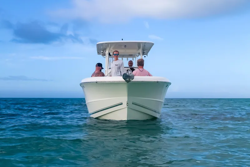 Slide: The Image of 2017 Key West Billistic 261 Center Console boat on open water with passengers. - 8