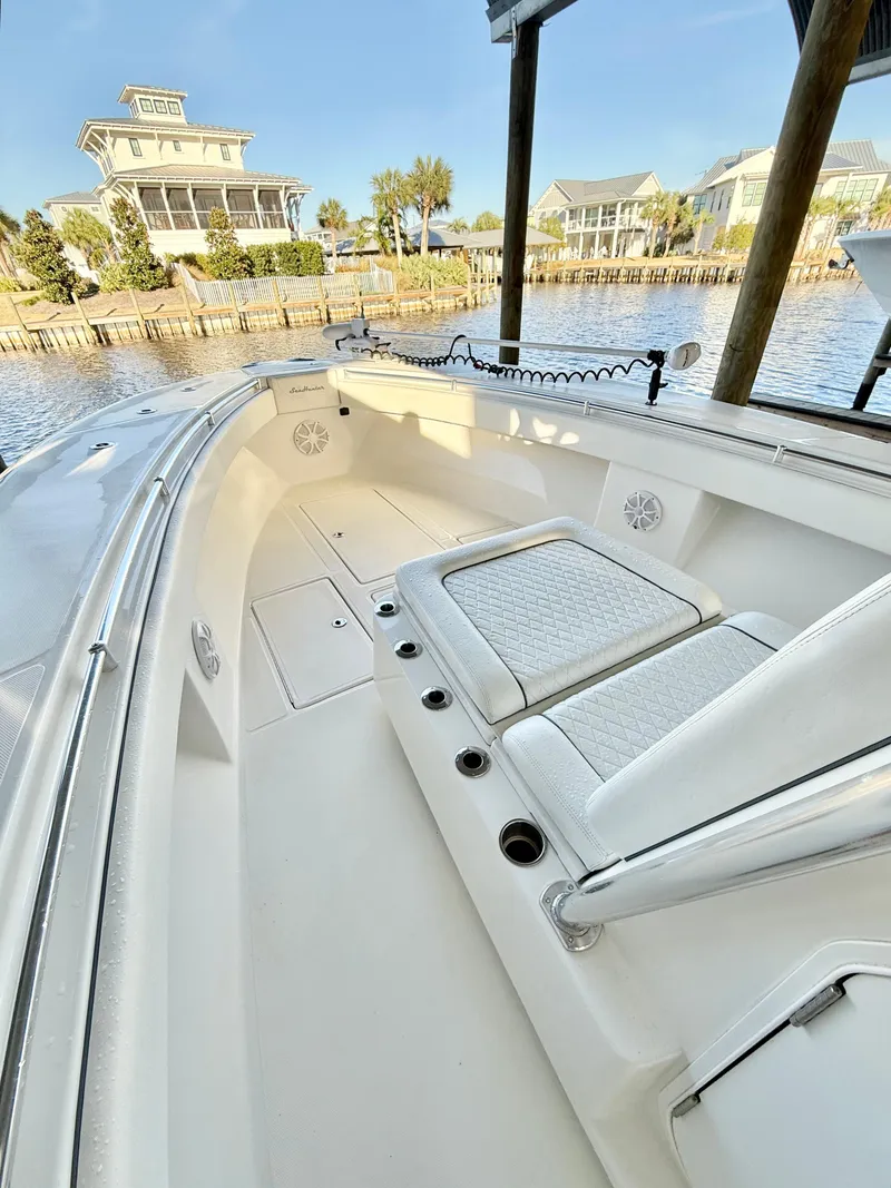Slide: The Image of 2021 SeaHunter 35 Tournament boat, spacious deck, docked by waterfront homes. - 10