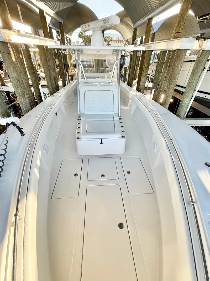 Slide: The Image of 2021 SeaHunter 35 Tournament boat, sleek design, spacious deck, docked in a marina. - 11
