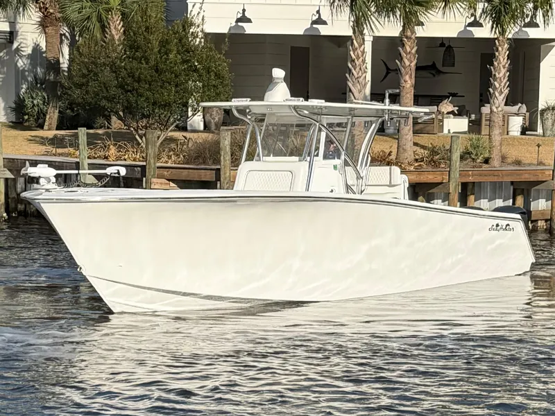 Slide: The Image of 2021 SeaHunter 35 Tournament boat docked by palm trees. - 3