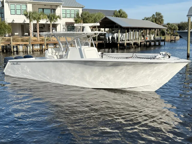 Slide: The Image of 2021 SeaHunter 35 Tournament boat docked in a marina, reflecting sunlight on calm water. - 5