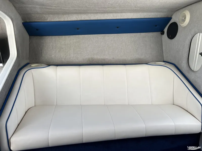 Slide: The Image of White leather seating in a 2002 Nordic 28 Heat MCOB boat interior. - 14