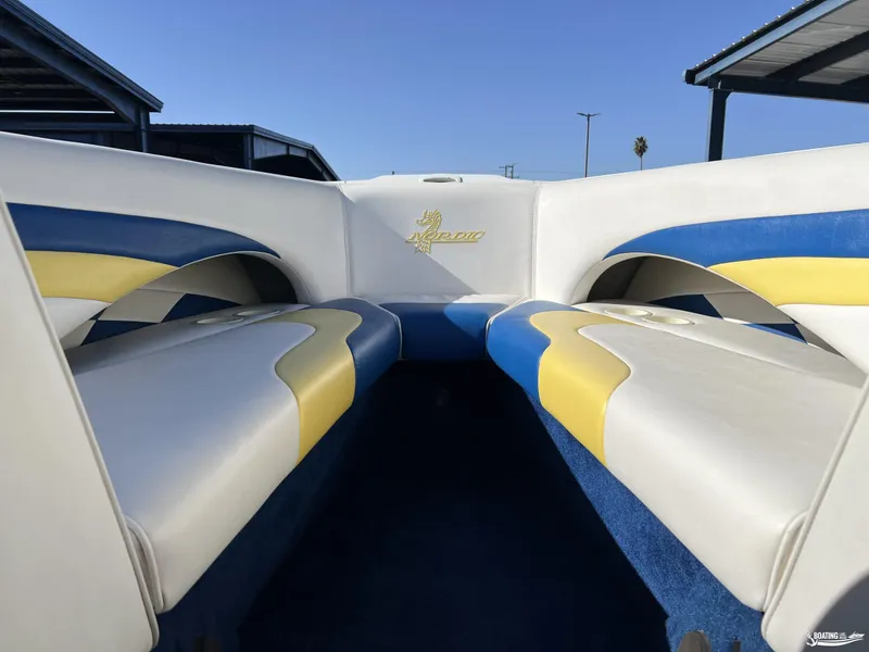 Slide: The Image of Interior of a 2002 Nordic 28 Heat MCOB boat with colorful seating. - 17