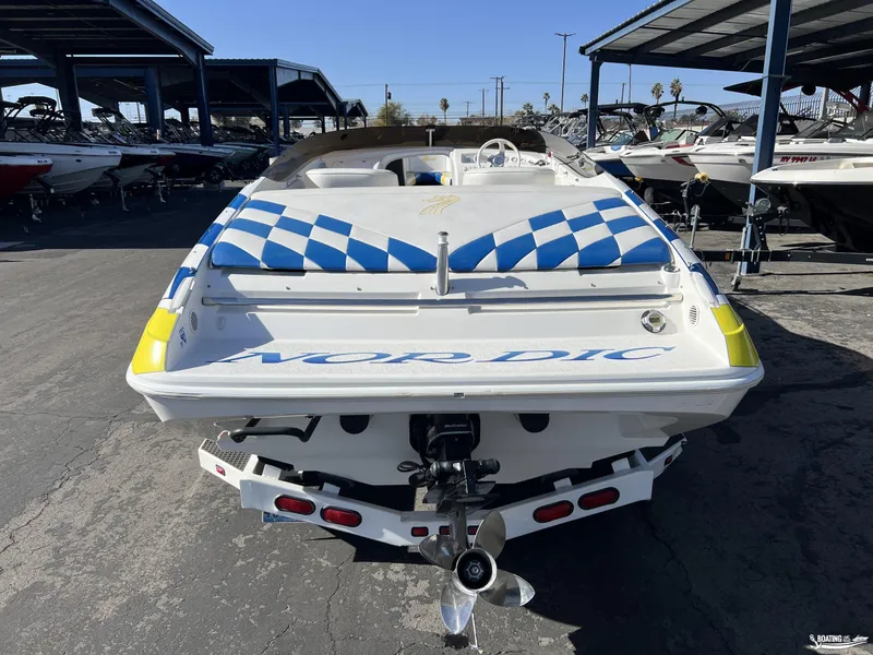 Slide: The Image of 2002 Nordic 28 Heat MCOB boat, rear view, in a marina with other boats. - 3