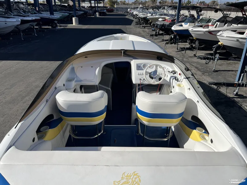 Slide: The Image of Interior view of a 2002 Nordic 28 Heat MCOB boat with white and blue seating. - 4