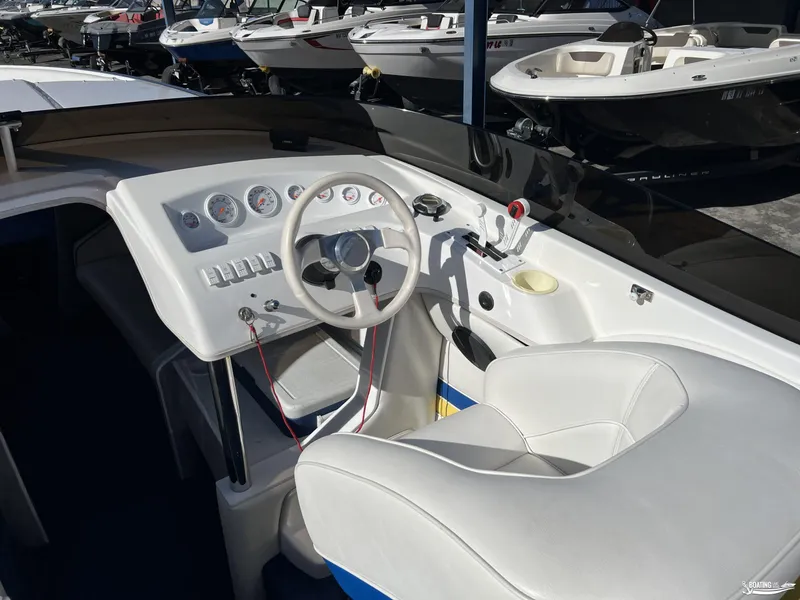 Slide: The Image of Interior of a 2002 Nordic 28 Heat MCOB boat with steering wheel and dashboard. - 5