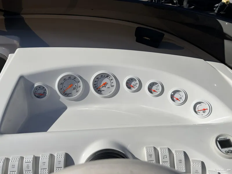 Slide: The Image of Dashboard of a 2002 Nordic 28 Heat MCOB boat with multiple gauges and switches. - 7